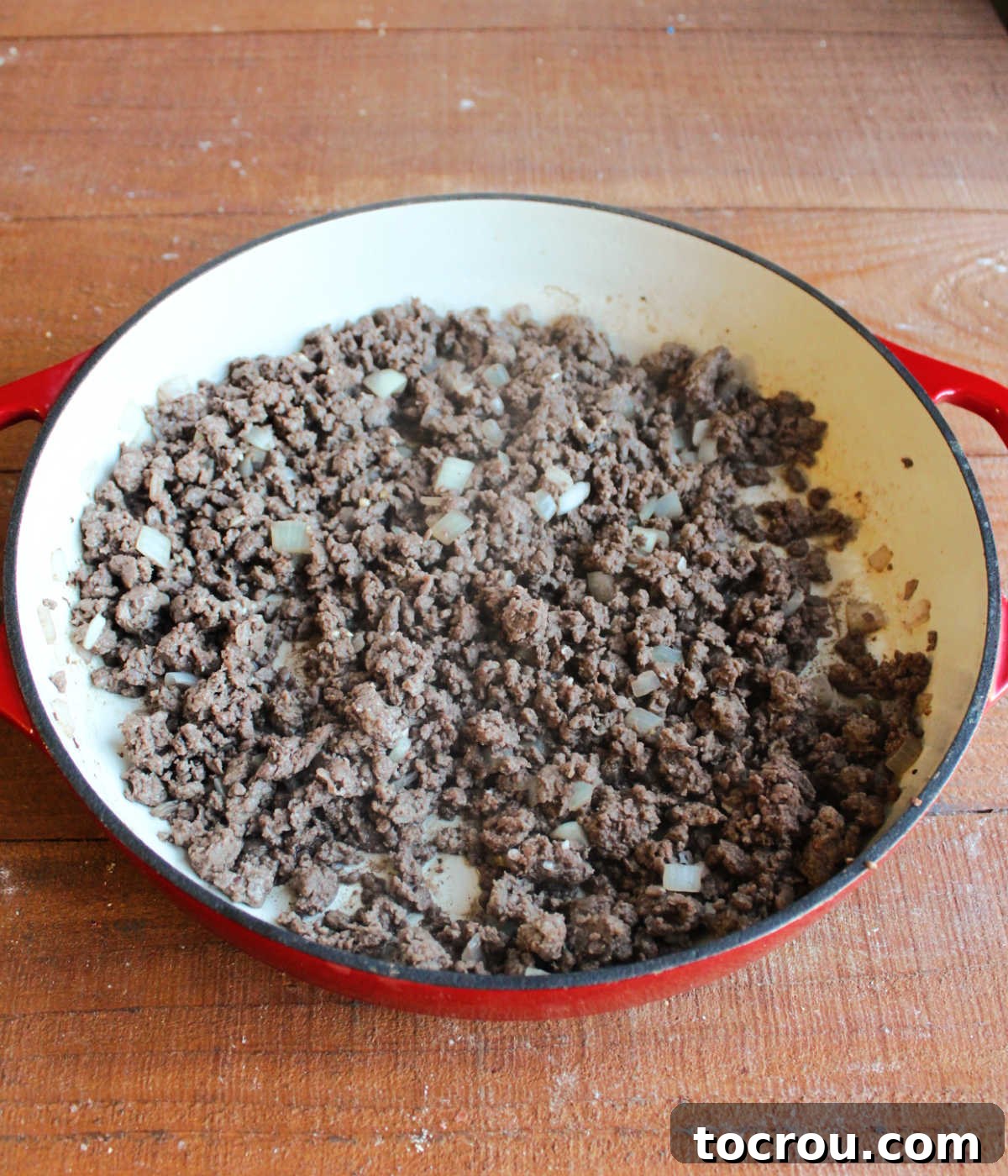Hearty Creamy Venison Mushroom Rice 4 Pan of browned ground venison with diced onions.