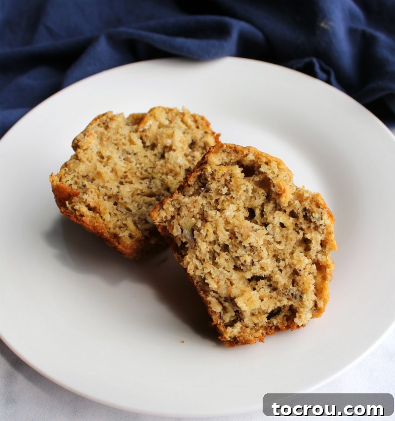 The soft, fluffy interior of a banana oat muffin that has been split in half, showing its delightful texture.