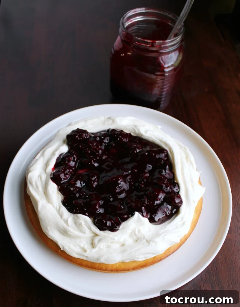 Blackberry Shortcake Bake 3 first layer of blackberry shortcake cake with fluffy white frosting and a nice helping of blackberry sauce.
