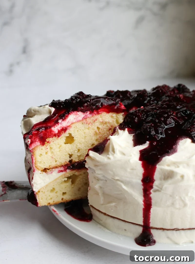 Blackberry Shortcake Bake 5 close up of first slice of blackberry shortcake cake being removed from the cake.