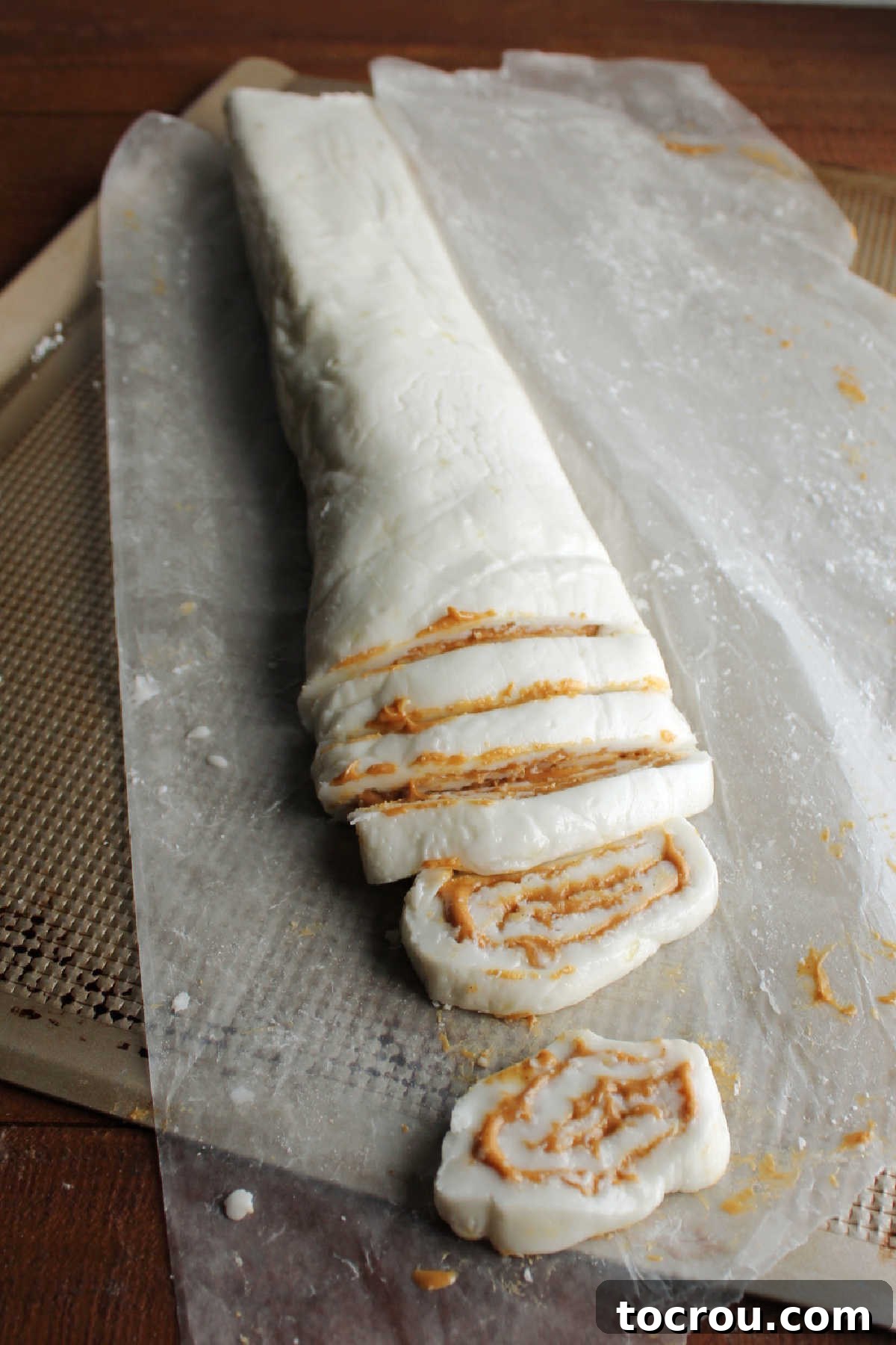 Slicing Potato Candy Pinwheels Cutting chilled potato candy into individual slices of peanut butter pinwheels.