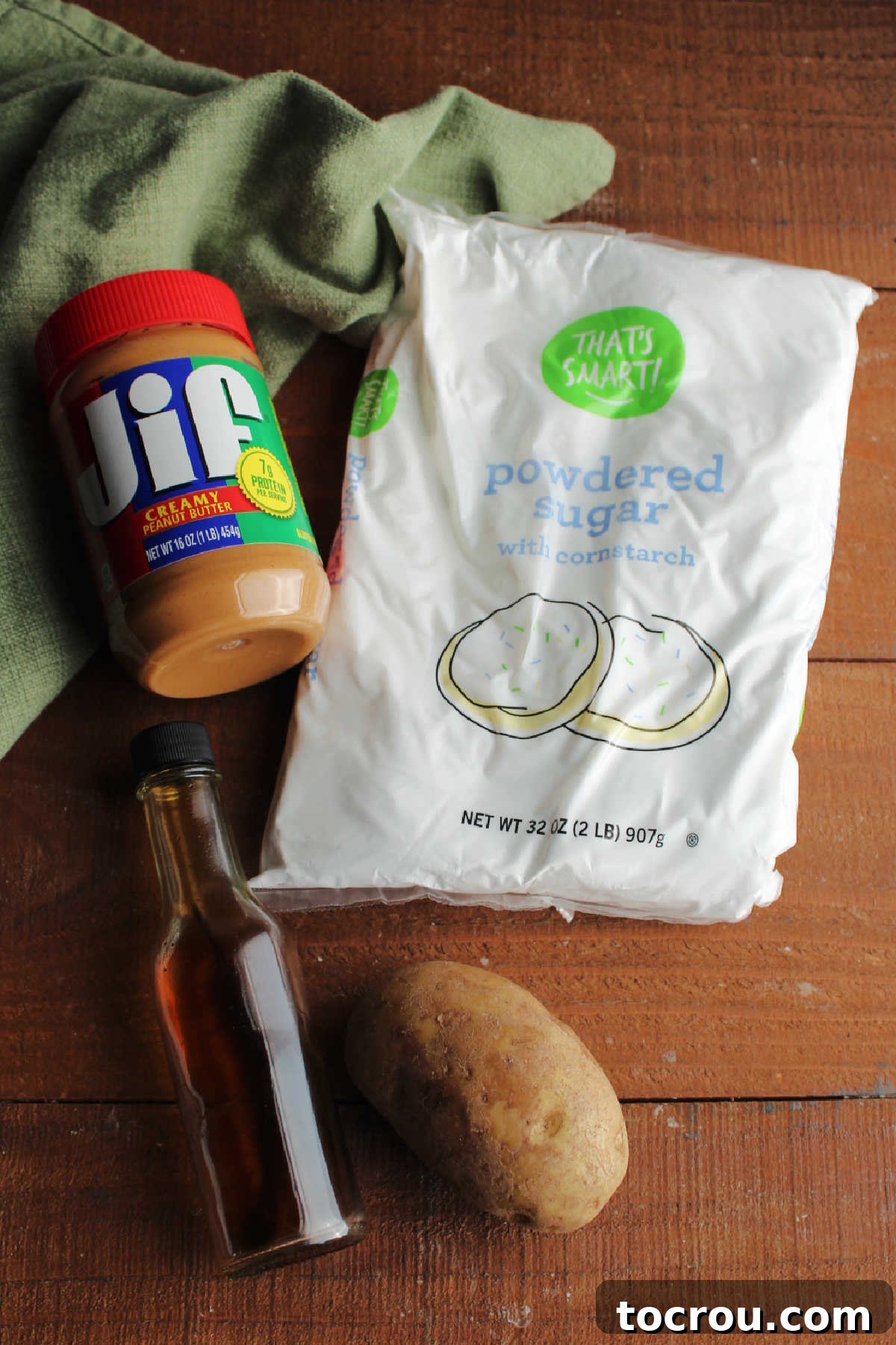 Simple Ingredients for Potato Candy Ingredients: russet potato, vanilla extract, peanut butter, and powdered sugar ready to be made into peanut butter pinwheels.