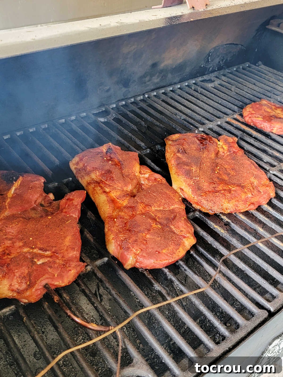 Smoky Perfection: Pellet Grill Pork Steaks 5 Smoked pork steaks with dry rub, they are partially cooked and ready for the sauce.