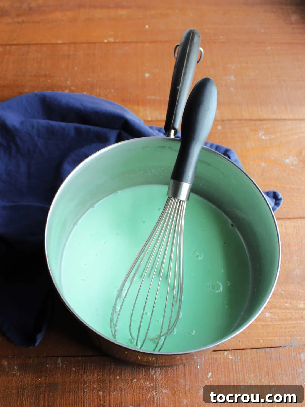 Saucepan with jello, milk, sugar and baking soda mixed together inside, ready to be cooked.