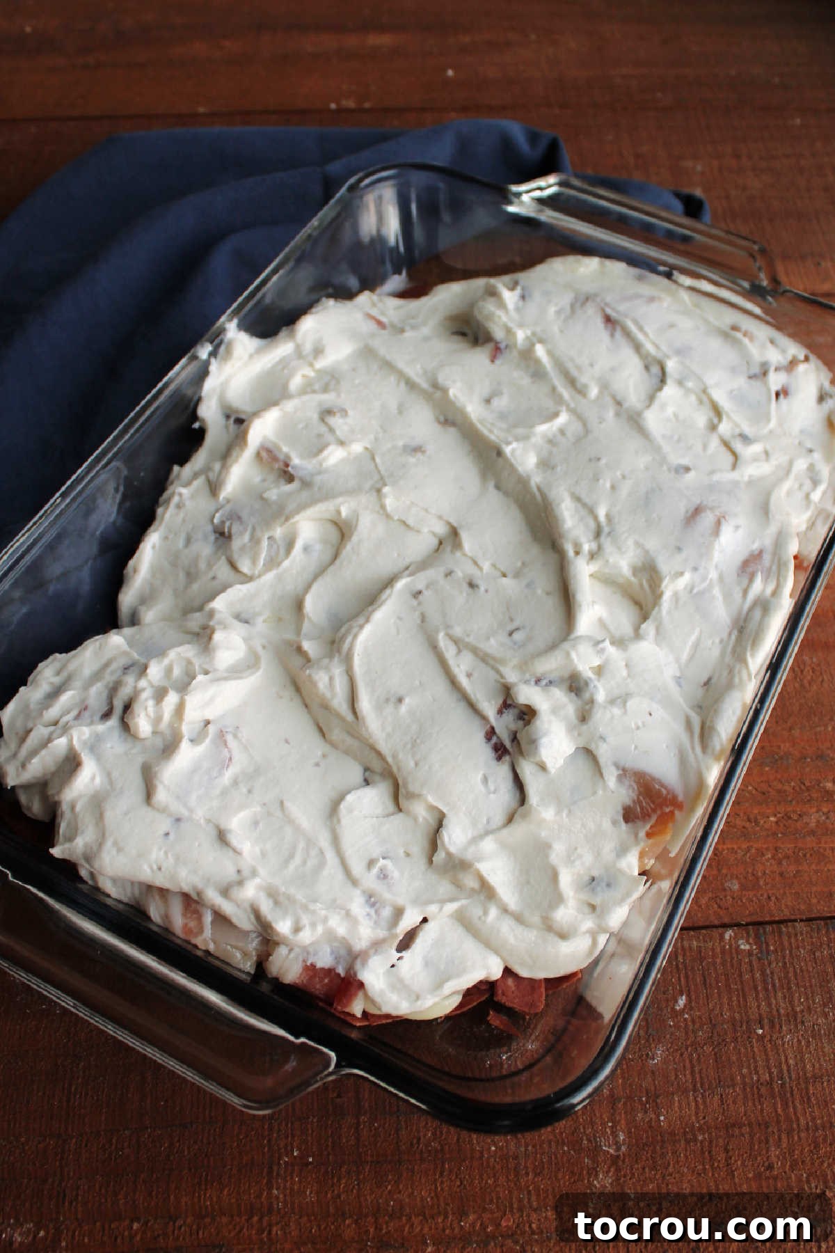 Sour cream and cream of mushroom soup mixture spread over the pan of chicken.