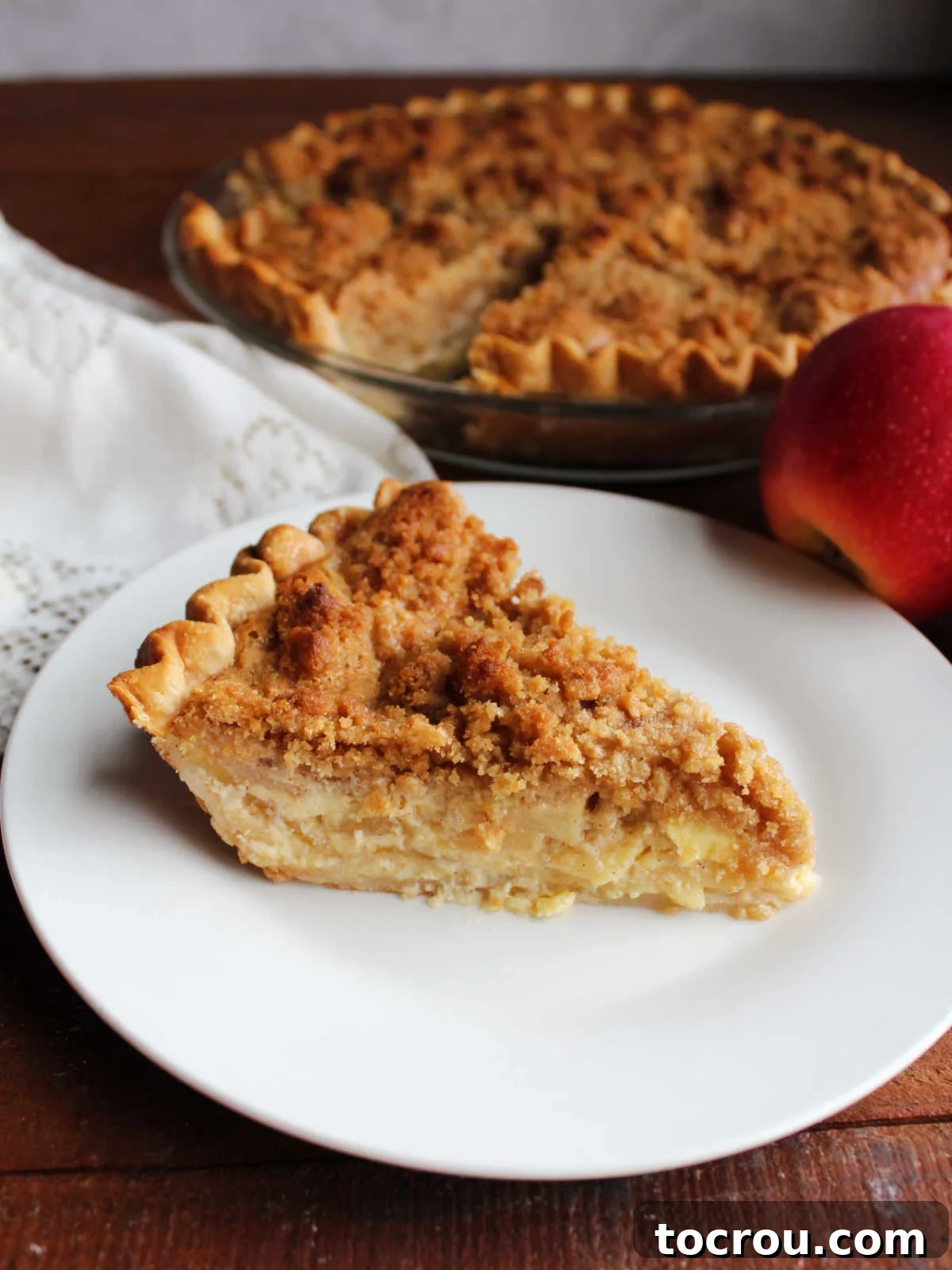 Apple Custard Crumble Pie 13 Slice of apple custard pie showing the creamy condensed milk mixture baked around the apple slices and the buttery crumb topping.