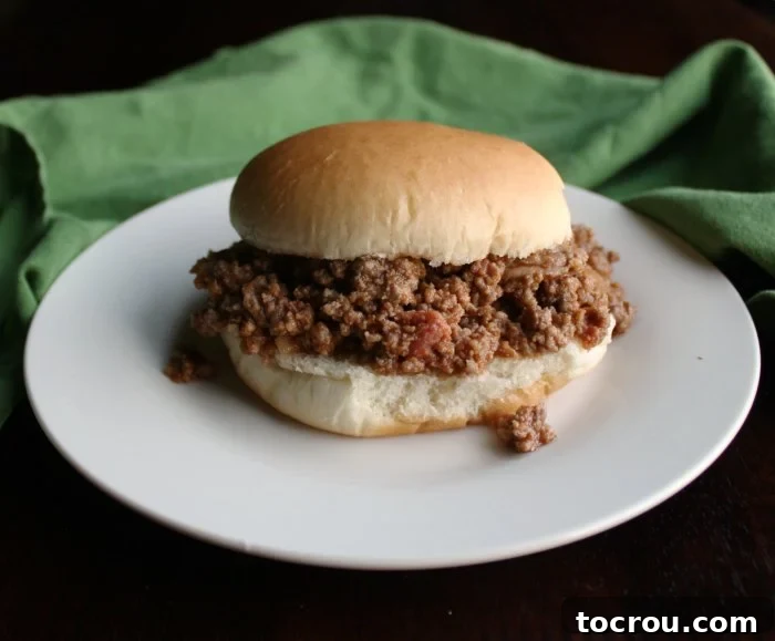 Crumbled sloppy joe meat with rich tomato sauce on a soft bun, ready to be served at a party or family reunion.