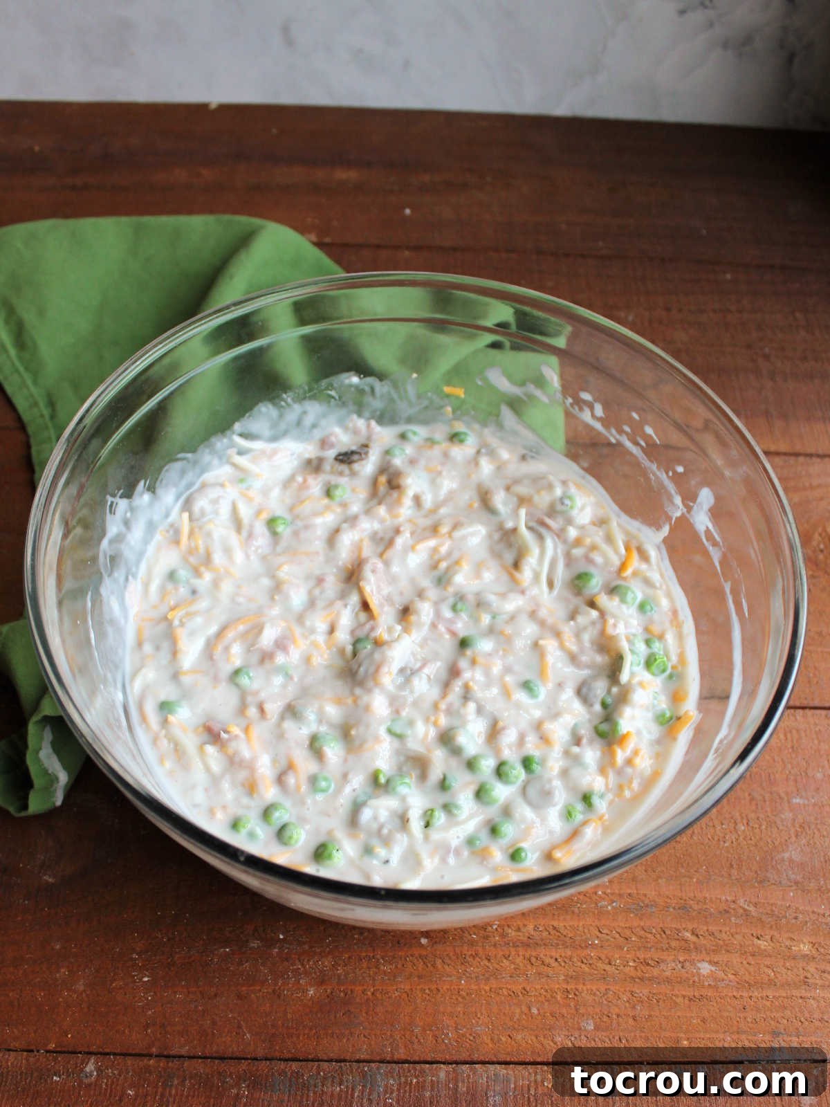 Hearty Tuna Noodle Casserole 5 Creamy sauce mixture, ready for cooked pasta, stirred together in a mixing bowl.