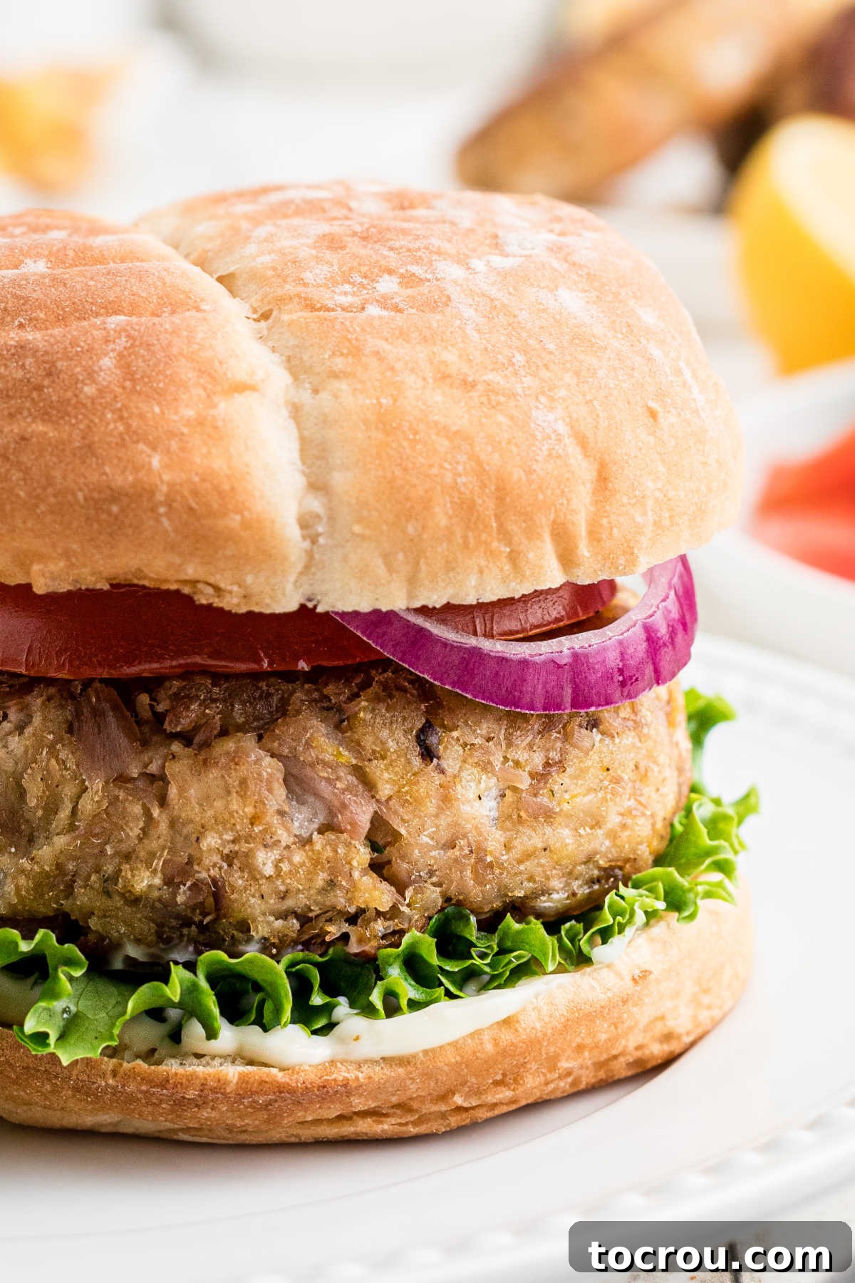 Close up of tuna patty on bun showing the thick meaty tuna patty and how well it held together.