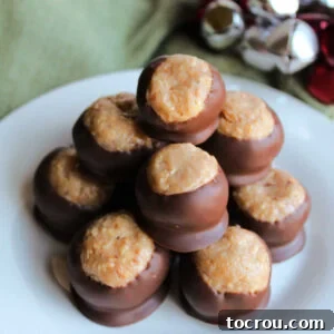 Caramel Peanut Balls Top View Stack of caramel peanut balls showing centers made from tiny bits of peanuts in caramel mixture dipped in chocolate leaving some of the center showing.