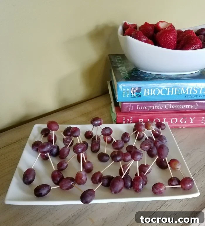 Fresh green grapes meticulously assembled with toothpicks to creatively resemble various chemical compounds, ideal for a science party snack.