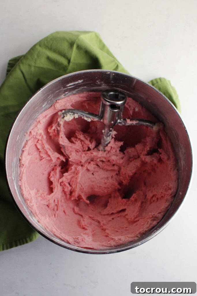 Mixing bowl filled with pink strawberry buttercream.