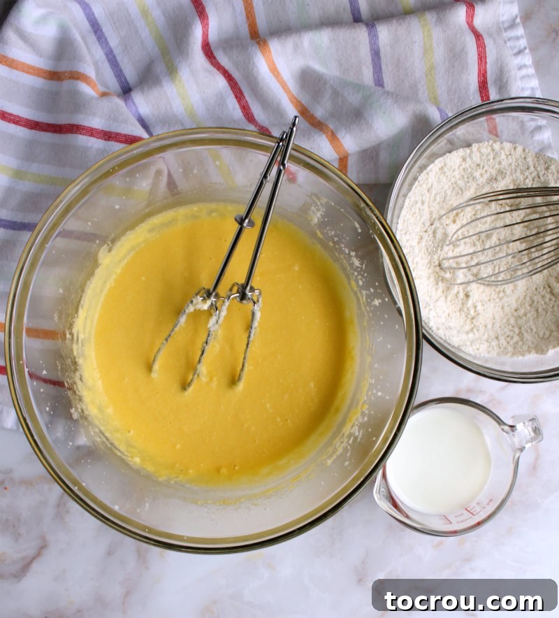 bowls of fresh ingredients for baking vanilla cupcakes, including flour, sugar, butter, and eggs.