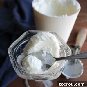 Spoon getting a bite of smooth vanilla half and half ice cream.