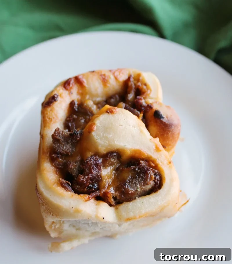 Close-up of Cheesy BBQ Pulled Pork Bun soft and cheesy bbq pulled pork bun on plate ready to eat.