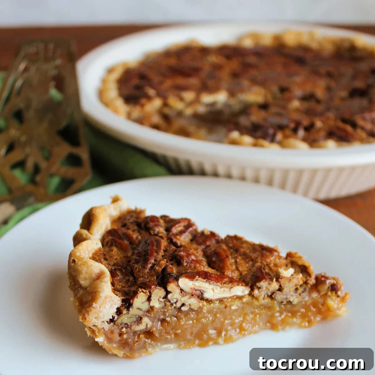 Timeless Pecan Perfection 2 Slice of classic pecan pie with golden crust, gooey filling and lots of pecans on top.