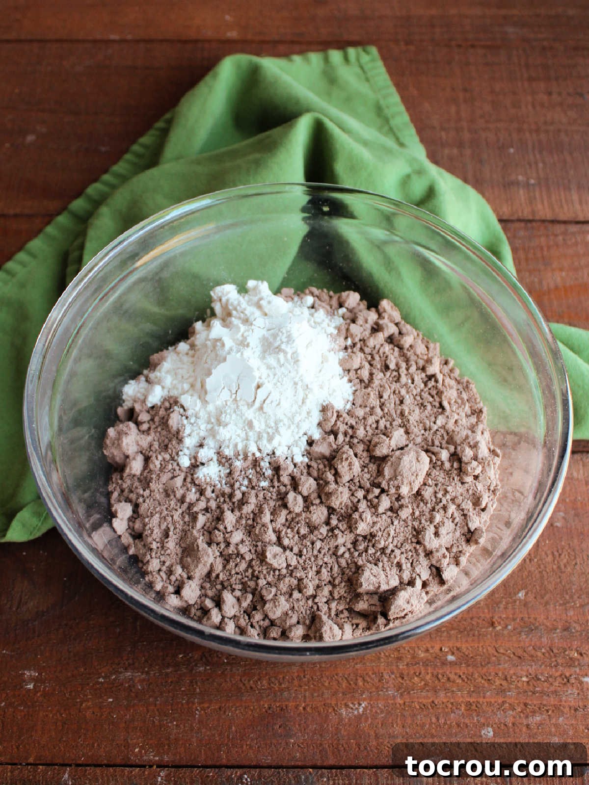 One-Bowl Brownie Cookies 4 A large glass mixing bowl containing brownie mix and all-purpose flour, perfectly combined and ready for wet ingredients.