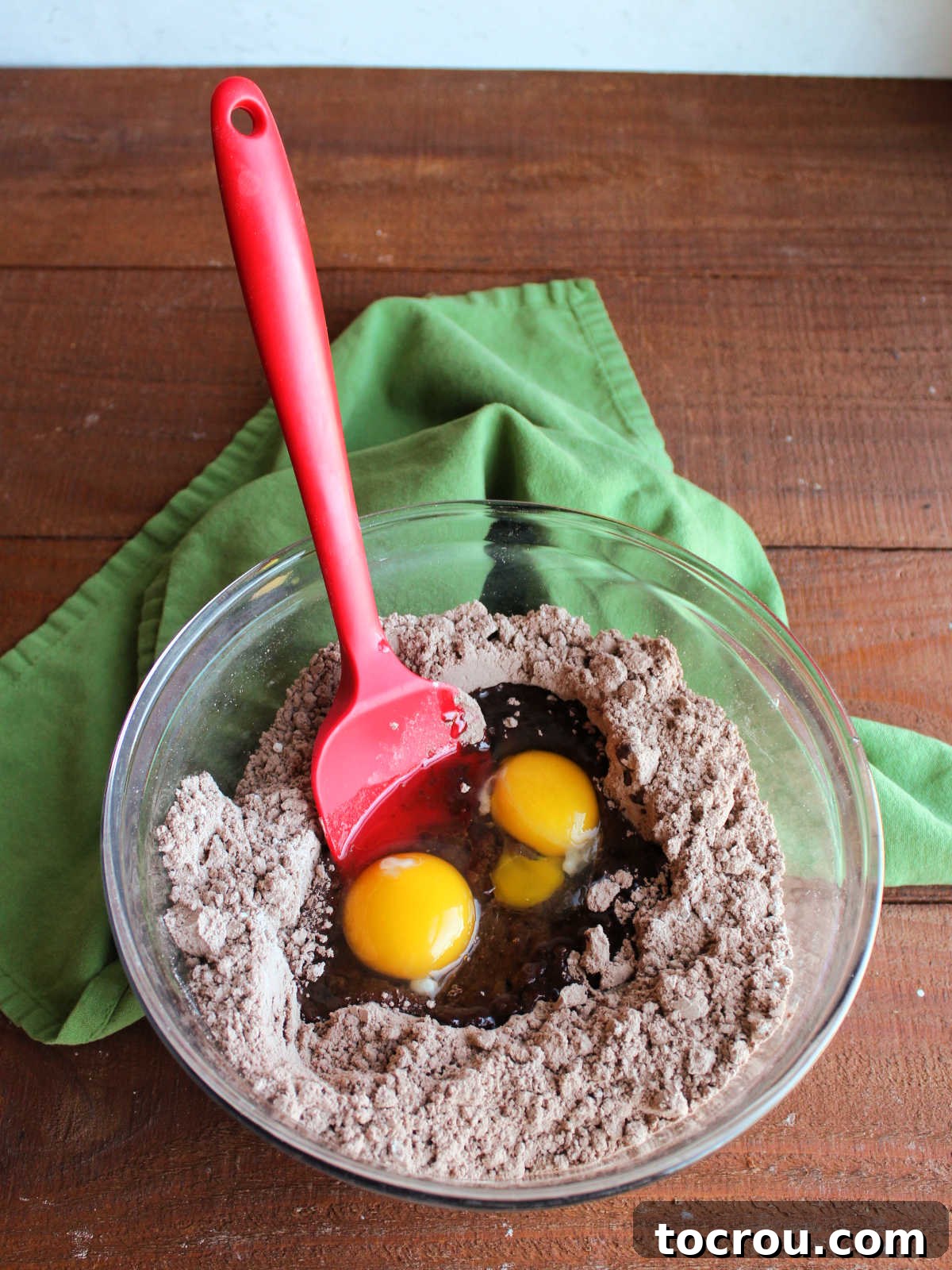 One-Bowl Brownie Cookies 5 Combining wet ingredients into the dry brownie mix and flour in a mixing bowl for brownie mix cookies.