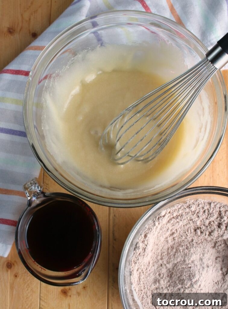Chocolate Velvet Indulgence 2 Bowls filled with mayonnaise mixture, dry ingredients, and brewed coffee, ready for mixing to create the perfect chocolate mayonnaise cake.