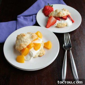 Two plates, one with a peach brunch shortcake and one with sliced strawberries and yogurt in a biscuit.