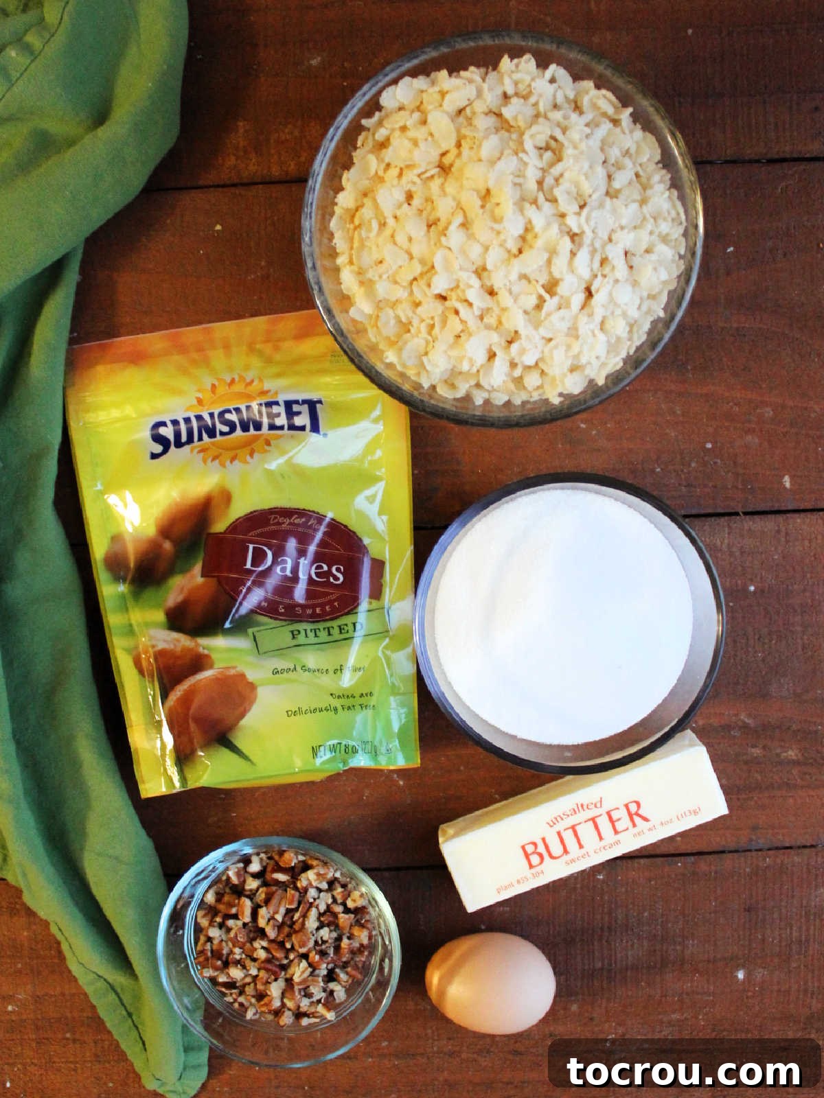 Grandma's Date Treats 4 Ingredients including dates, pecans, an egg, butter, sugar, and rice krispies ready to be made into date balls.