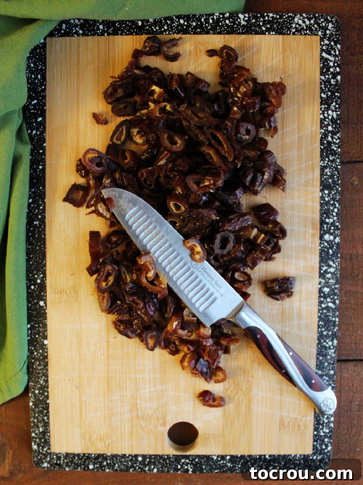 Grandma's Date Treats 5 Cutting board with chopped dates and a knife.
