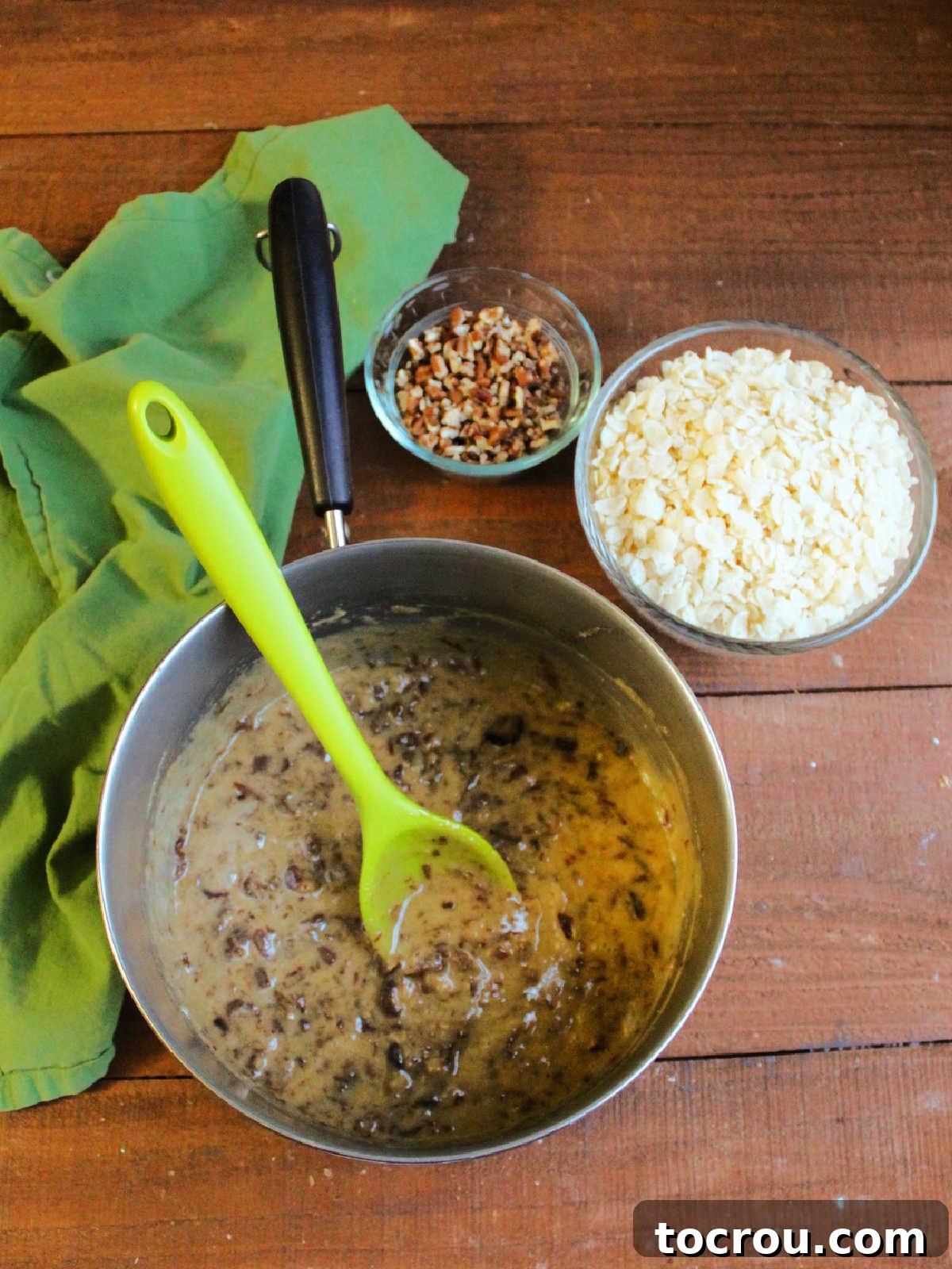 Grandma's Date Treats 6 Saucepan with date, butter, sugar, and egg mixture next to bowl of rice Krispies and a bowl of chopped pecans.