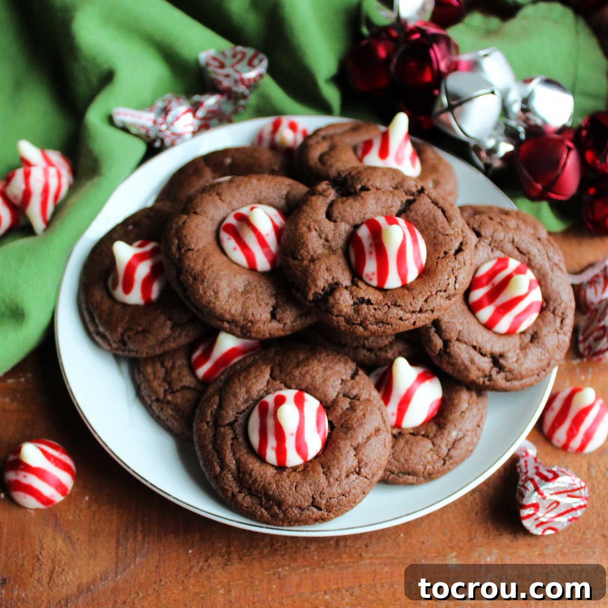Peppermint Kissed Chocolate Blooms 2 Plate of chocolate blossom cookies with red and white striped peppermint kisses in the center, festive and inviting.