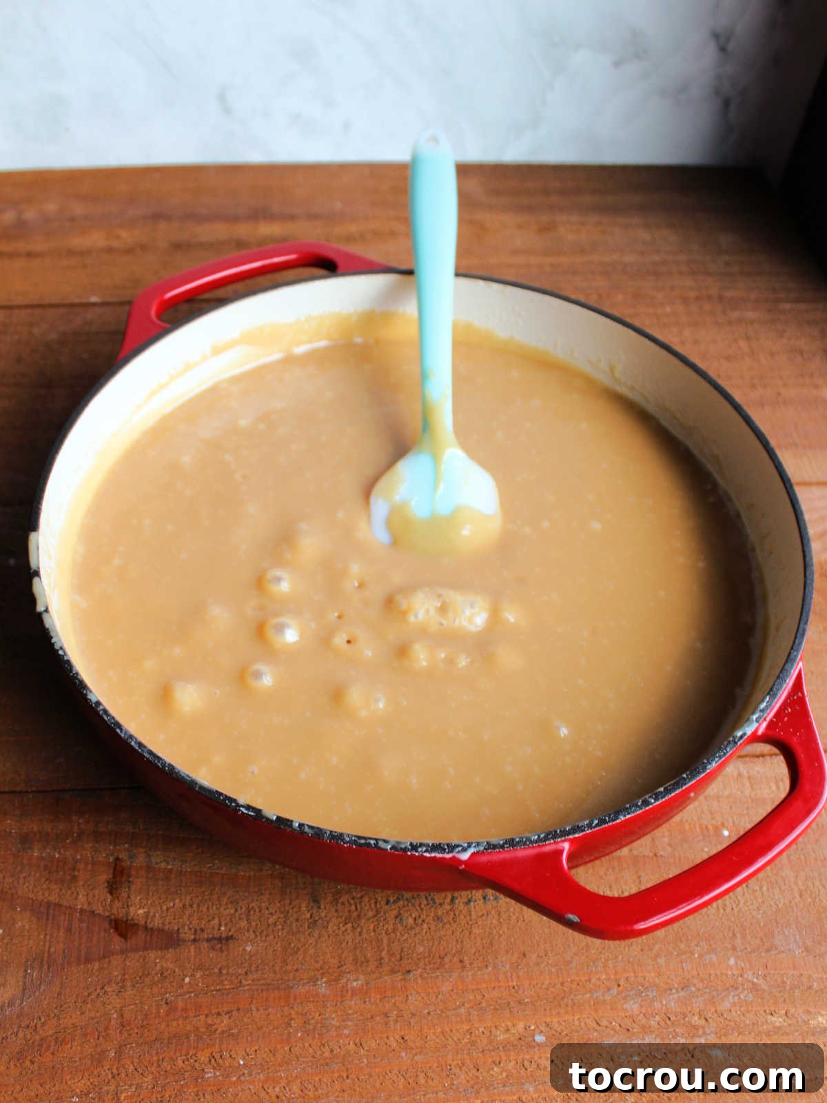 Cooked caramel mixture in pan, ready to go on pecans.