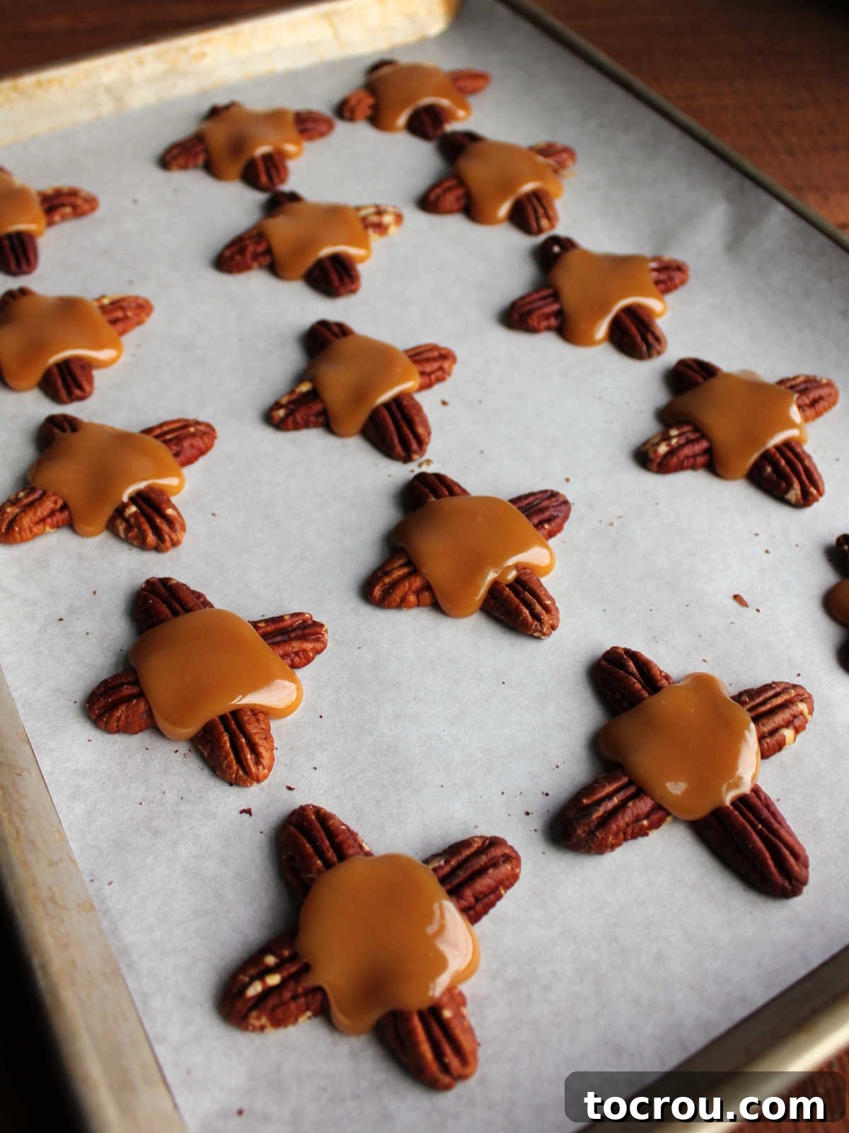 Caramel circles in the middle of pecans holding them together.