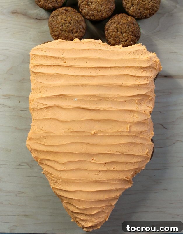 Pull-Apart Carrot Cake: A Cupcake Masterpiece 6 Close-up of the carrot cupcake cake showing realistic ridges and lines carefully formed into the orange frosting, mimicking the natural texture of a carrot. This detail adds depth and visual appeal to the dessert.