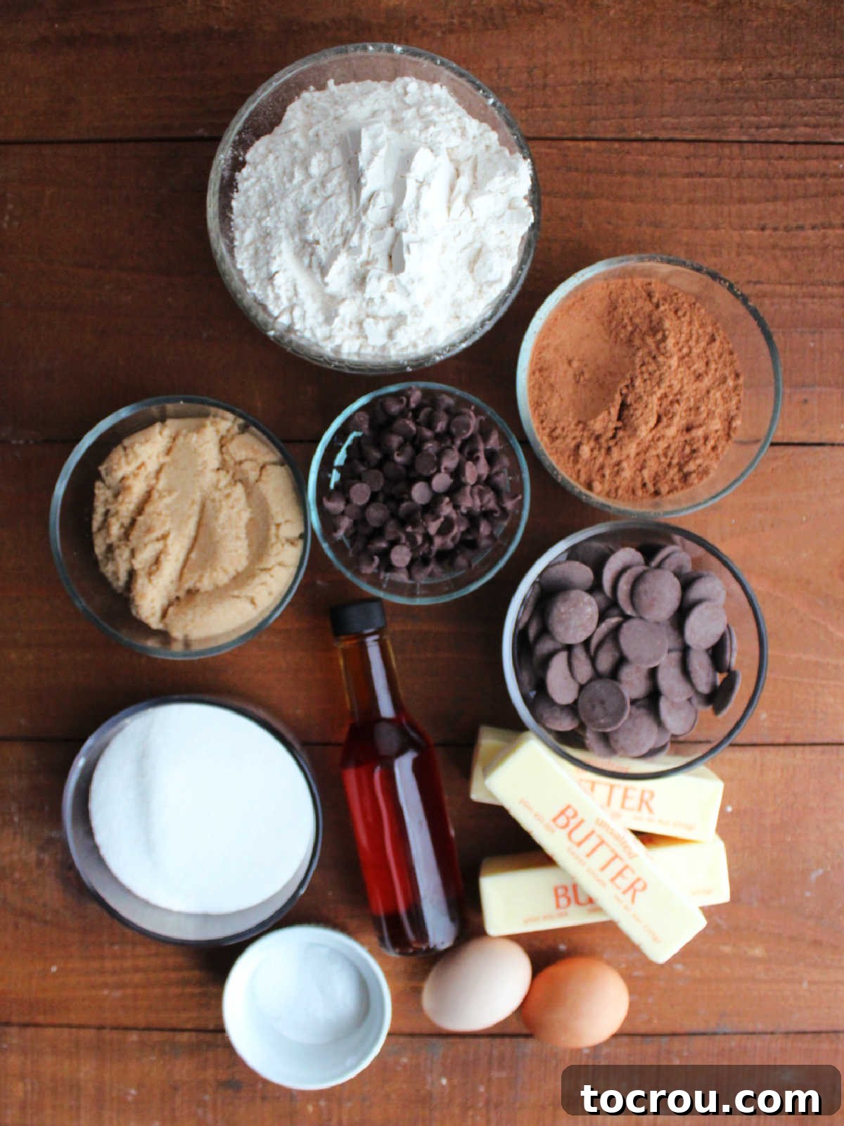 Fudgy Paw Print Double Chocolate Cookies 3 Ingredients including butter, sugar, brown sugar, eggs, vanilla, flour, cocoa powder, salt, baking soda, chocolate chips, and chocolate melting wafers ready to be made into chocolate paw print cookies.