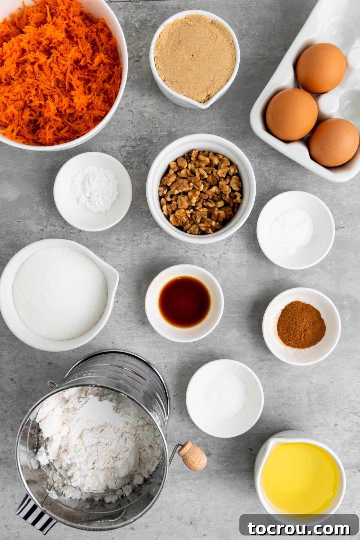 Rustic Carrot Cake Cupcakes 3 Ingredients including flour, sugar, eggs, vanilla, oil, cinnamon, brown sugar, shredded carrots, and chopped walnuts ready to be made into cupcakes.