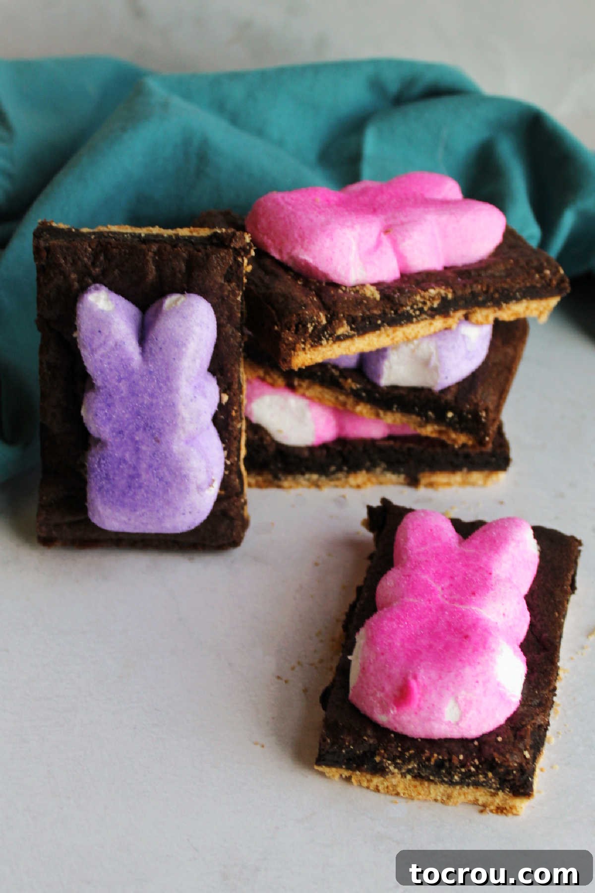 Colorful Peeps S'mores Bars, fresh from the oven. Chocolate cake mix s'mores bars topped with pink and purple peeps bunnies, ready to eat.