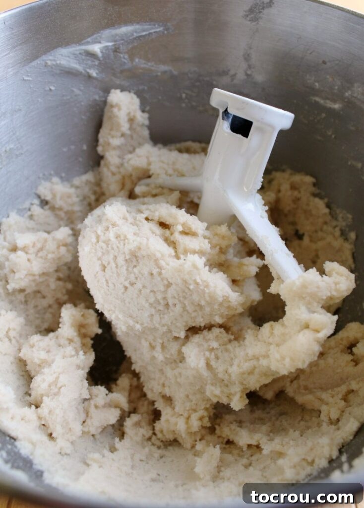 Mixing Sugar Cookie Dough Frosting mixing bowl of sugar cookie dough frosting with paddle.