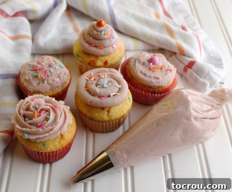 Variety of Frosted Cupcakes cupcakes with a variety of frosting decoration styles and piping bag.