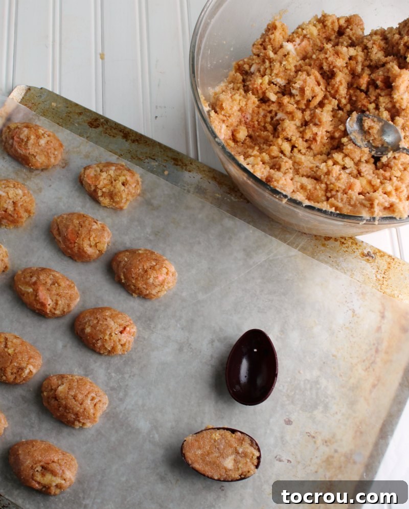making egg shaped cake balls from cake and frosting mixture.