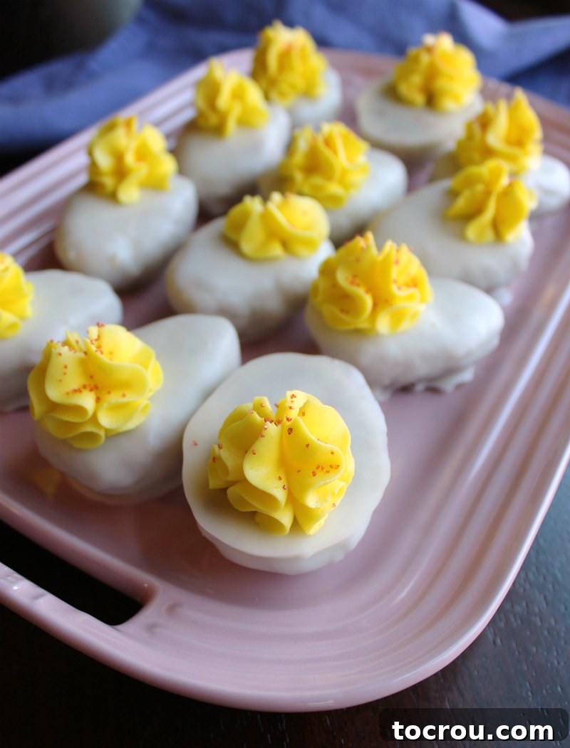 Pink serving platter filled with deviled egg shaped cake balls.