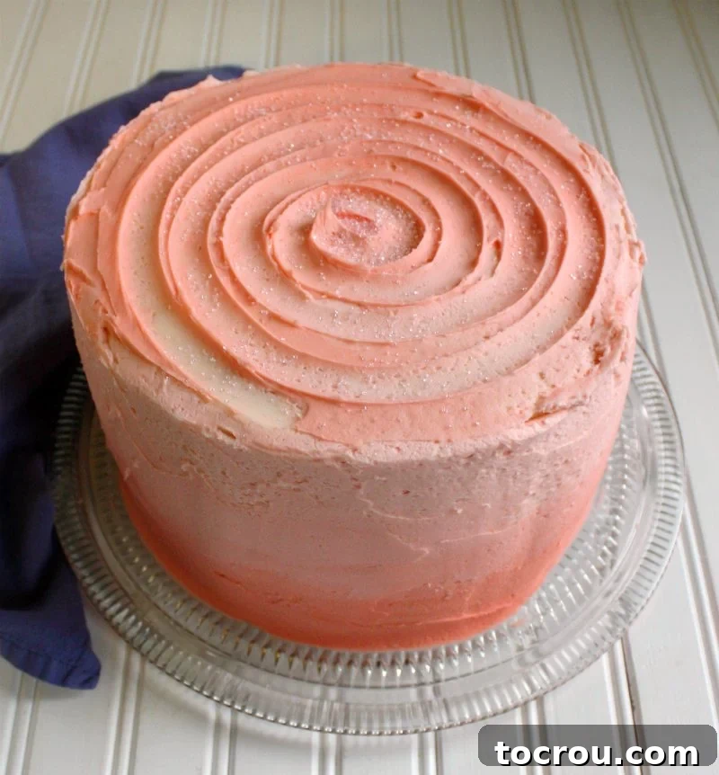 cake with pink ombre effect on the sides and a pink swirl on the top