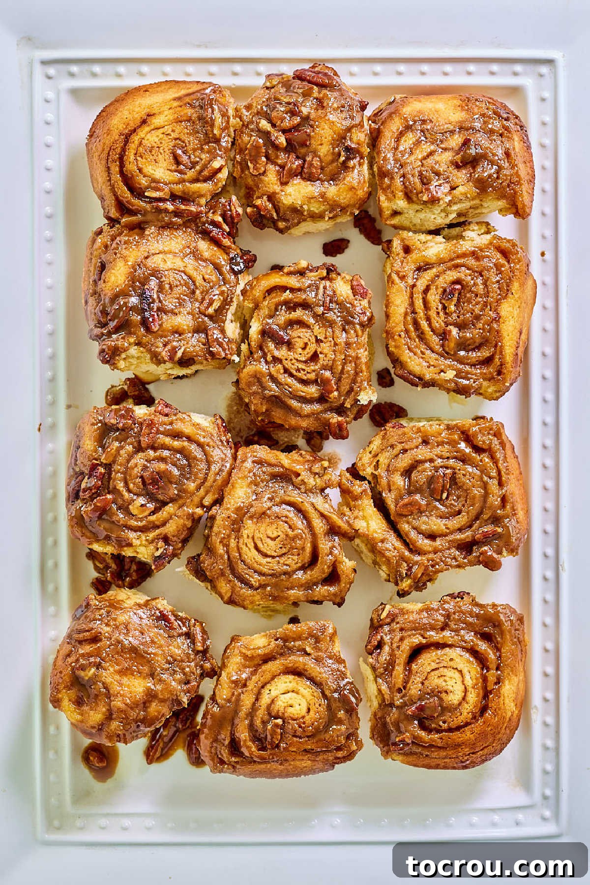 Warm caramel pecan rolls after they have been baked and removed from the pan.
