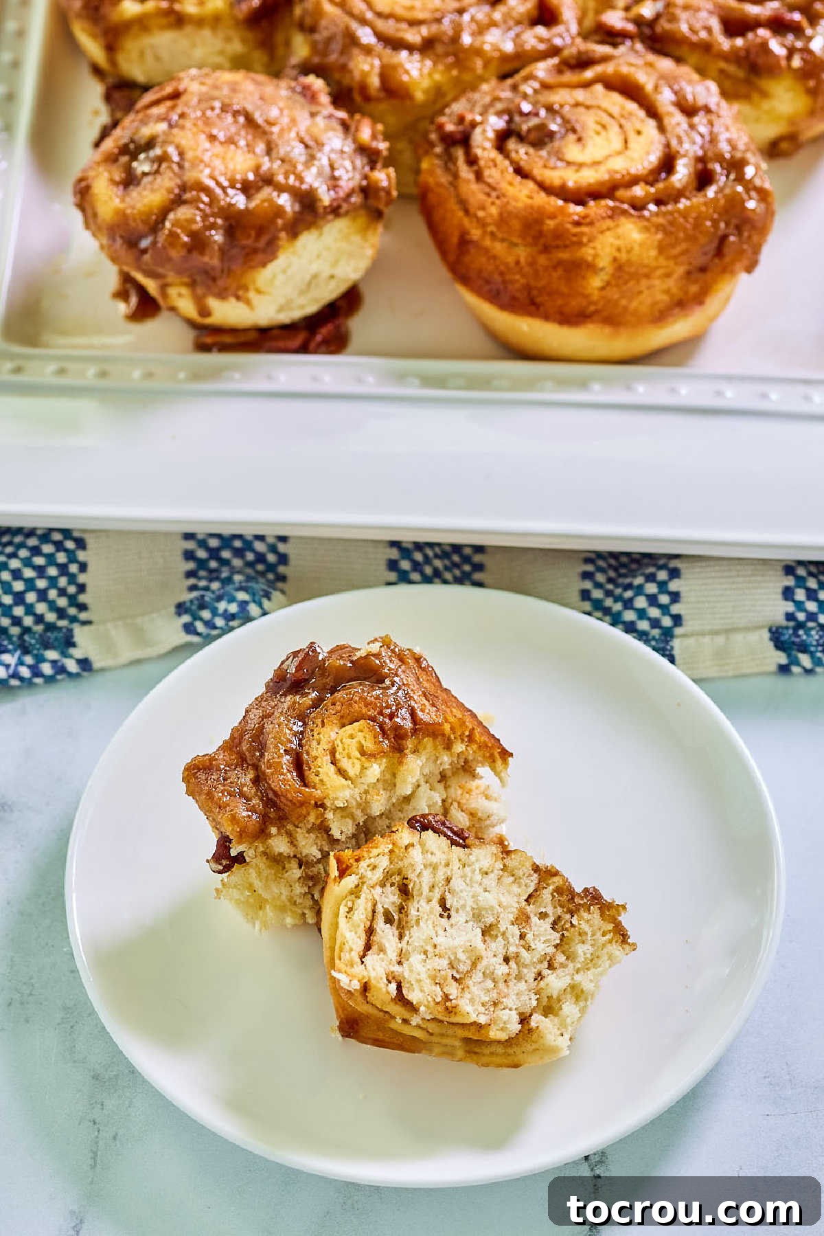 Small plate with warm caramel pecan roll, ready to eat.