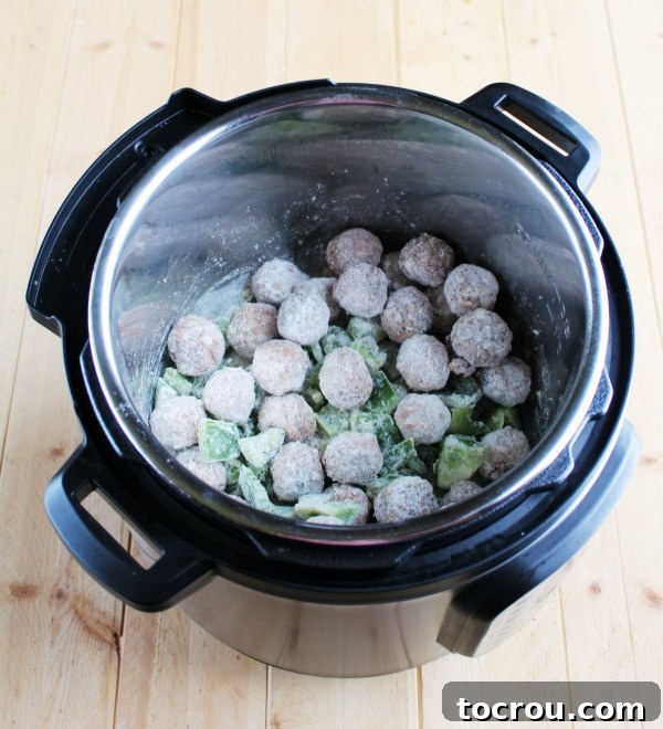 Instant Pot Swiss Steak Inspired Meatballs 2 frozen meatballs and green peppers tossed in flour in instant pot.