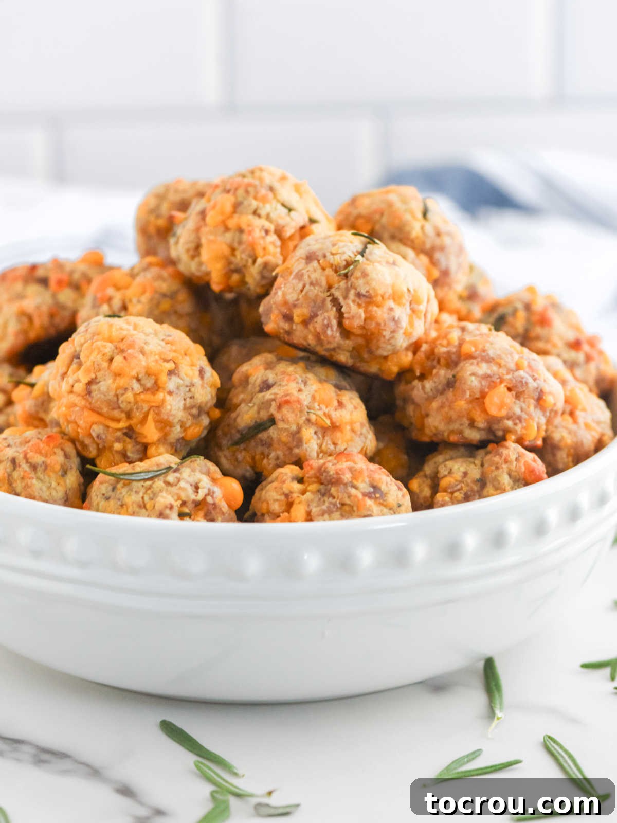 Sausage Cheese Bites 4 Bowl of sausage balls with cheddar cheese and pancake mix inside ready to be served.