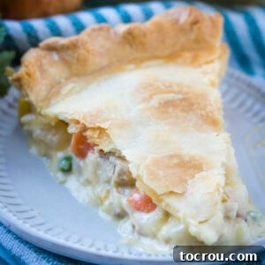 slice of pot pie with creamy chicken and vegetable filling.