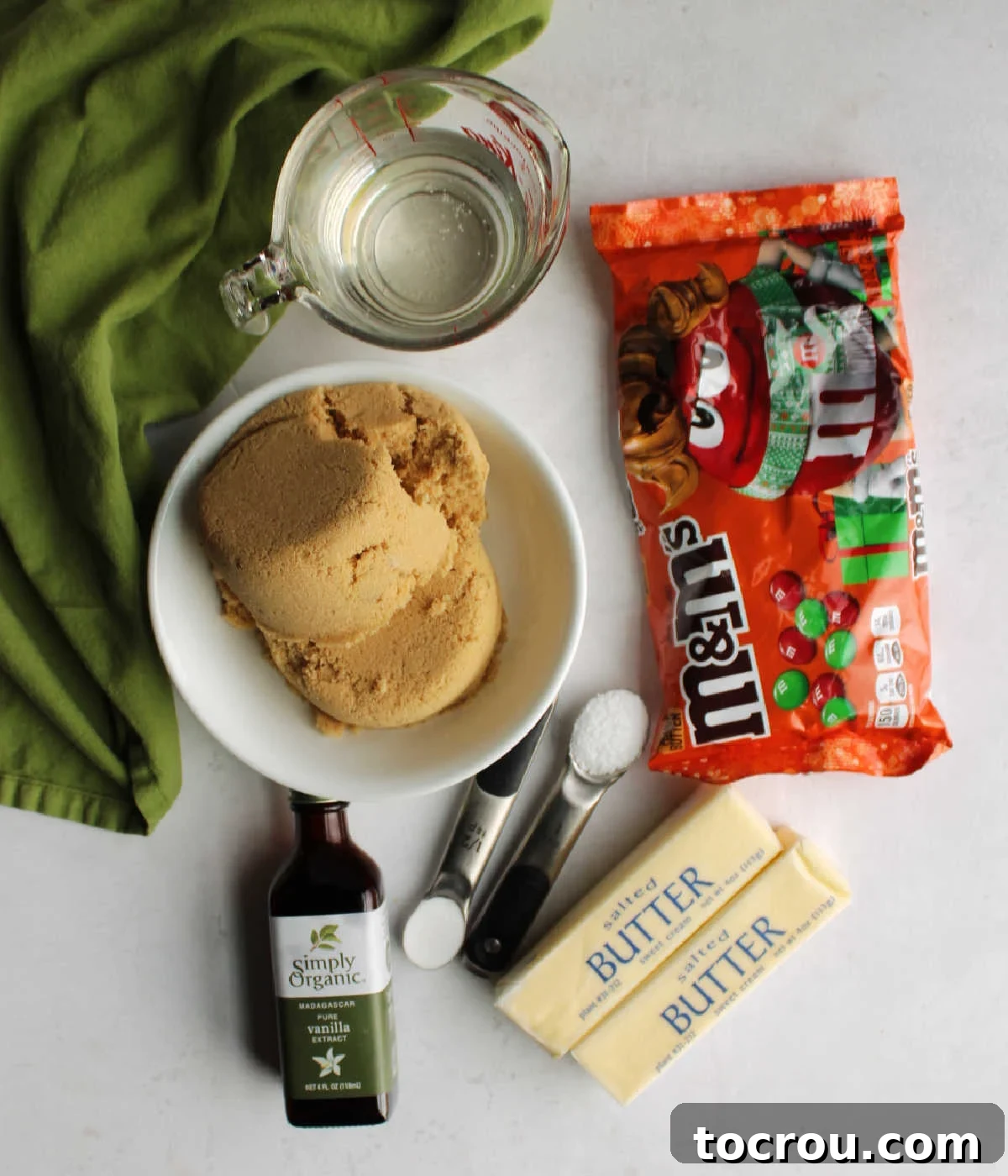 Caramel ingredients: Brown sugar, corn syrup, butter, salt, baking soda, vanilla and a bag of M&M's ready to make caramel mixture for Chex mix.