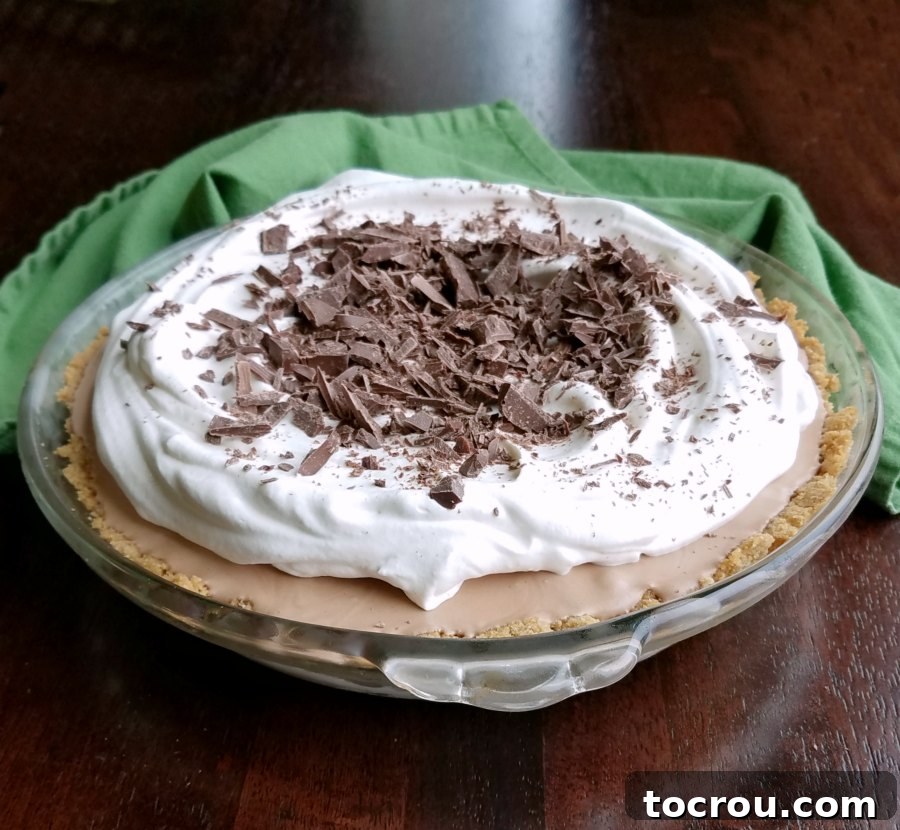Make this modern twist on an old favorite. This no churn frozen mint meltaway pie is a perfect make ahead holiday dessert. A beautifully presented no-churn frozen mint meltaway pie, garnished generously with fresh whipped cream and an abundance of finely chopped Frango mints, ready to be served and enjoyed.