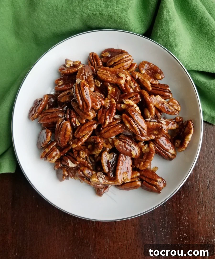 Bowl of shiny homemade candied pecans.