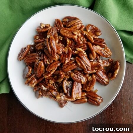 Bowl of shiny homemade candied pecans.