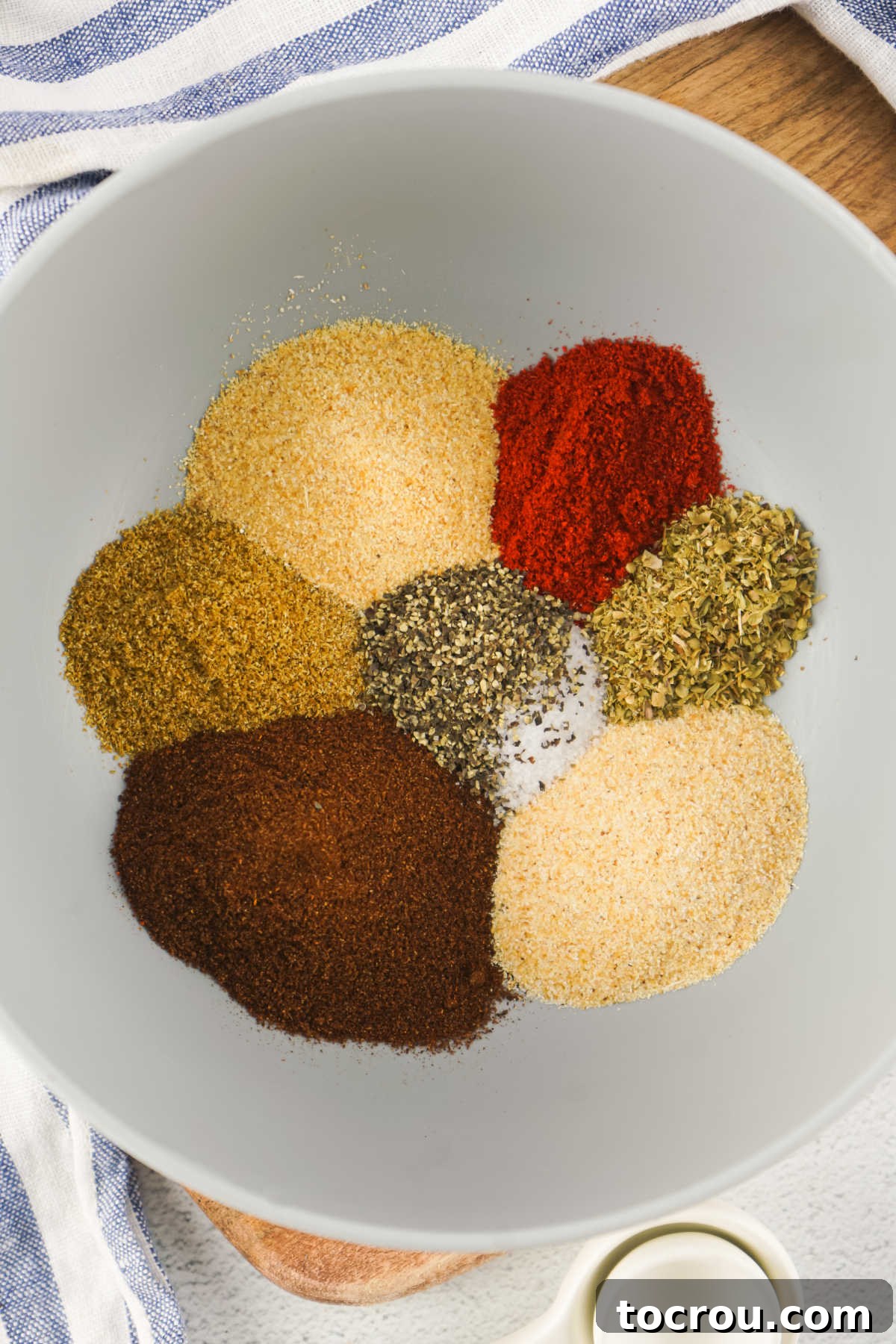 Mixing Taco Spices Individual spices in a small bowl, ready to be stirred together to make taco seasoning.