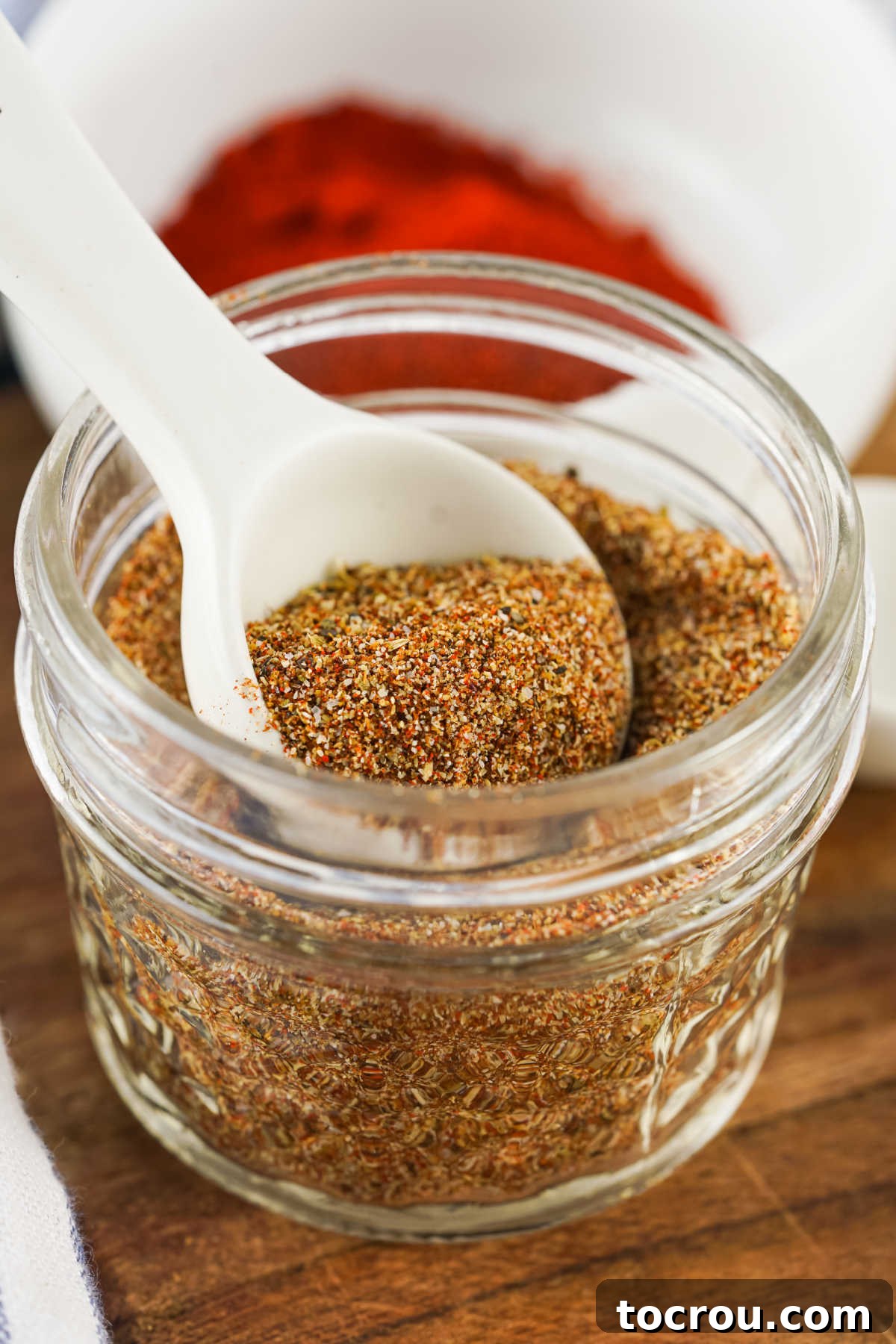 Taco Seasoning in Jar Measuring spoon in a jar of homemade taco seasoning mix.